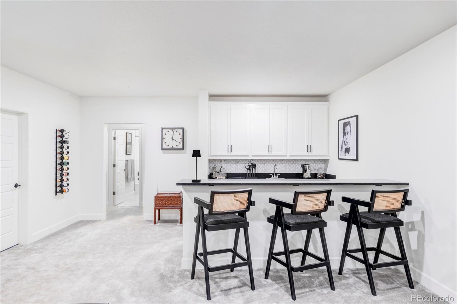 14395 Hop Clover Street Parker, CO 80134 - Photo 23 of 32 a kitchen with a table and chairs in it