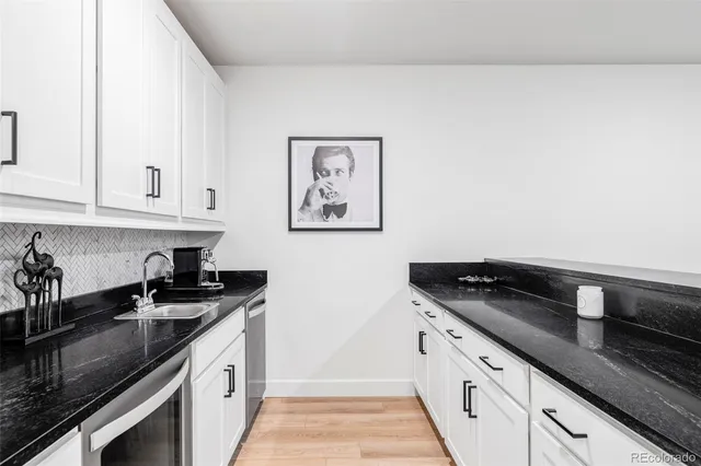 a kitchen with granite countertop a sink and cabinets