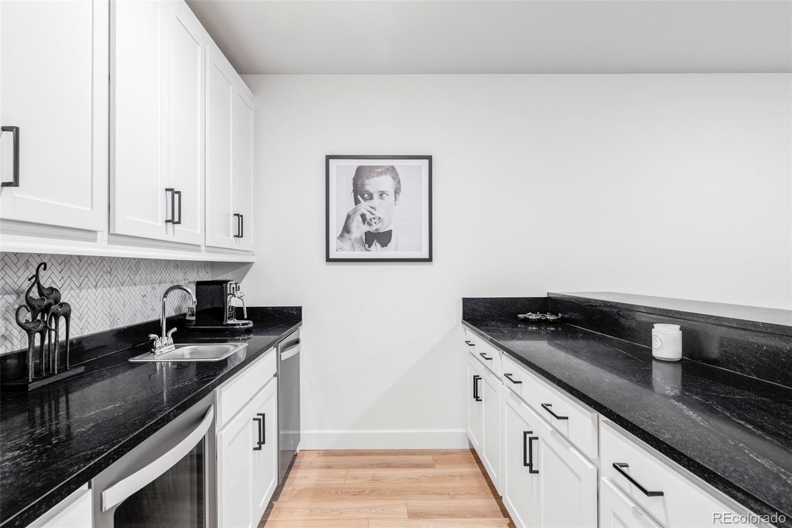 14395 Hop Clover Street Parker, CO 80134 - Photo 24 of 32 a kitchen with granite countertop a sink and cabinets