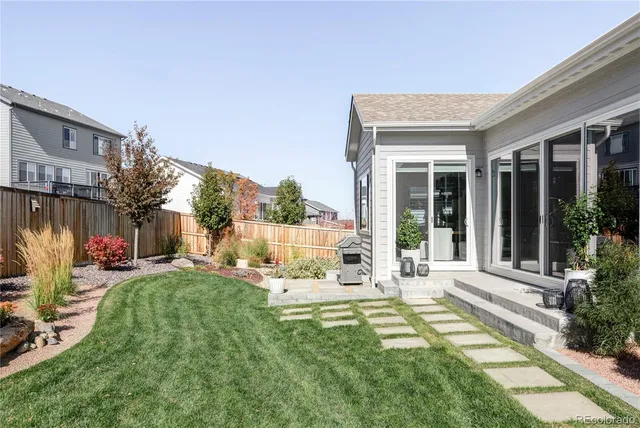 a view of a house with backyard sitting area and garden