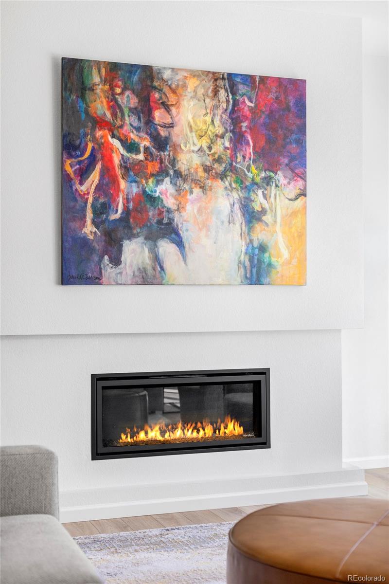 14395 Hop Clover Street Parker, CO 80134 - Photo 3 of 32 a view of fireplace with wooden floor