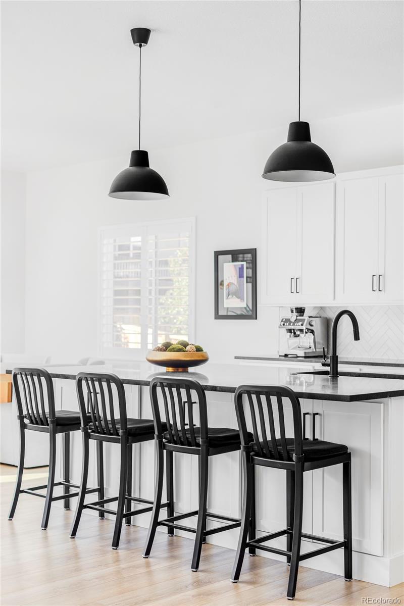 14395 Hop Clover Street Parker, CO 80134 - Photo 7 of 32 a view of a dining room with furniture and wooden floor