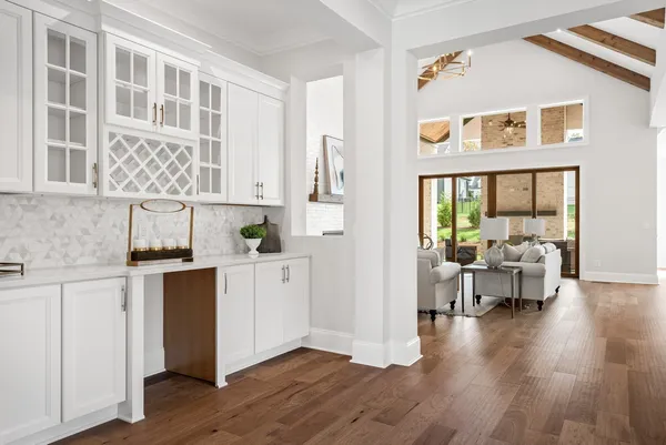 a living room with furniture a fireplace and a large window