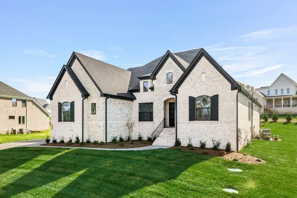 a front view of a house with a yard