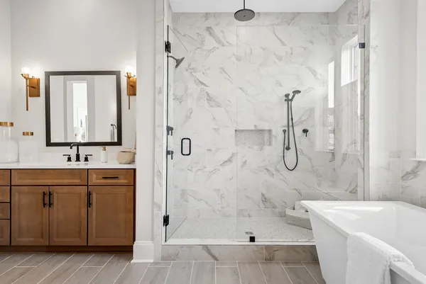 a bathroom with a sink a toilet and shower