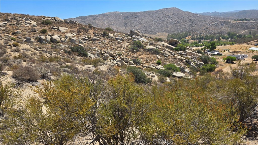 0 Leo Road Aguanga, CA 92536 - Photo 6 of 8 a view of a mountain range in a cloudy sky