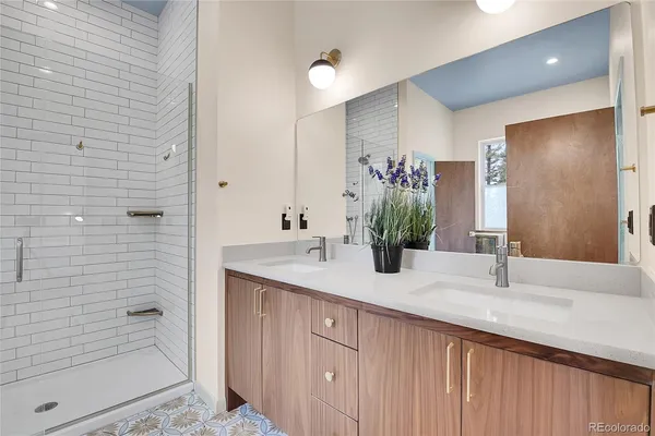 a bathroom with a granite countertop sink a toilet and shower