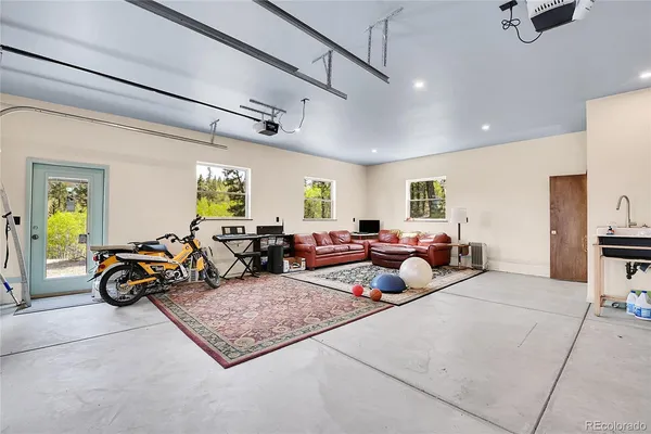 a bed room with two couches and a large mirror on the kitchen