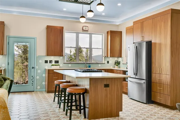 a kitchen with stainless steel appliances granite countertop a stove refrigerator and cabinets