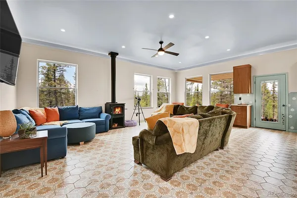 a living room with furniture potted plant and a large window
