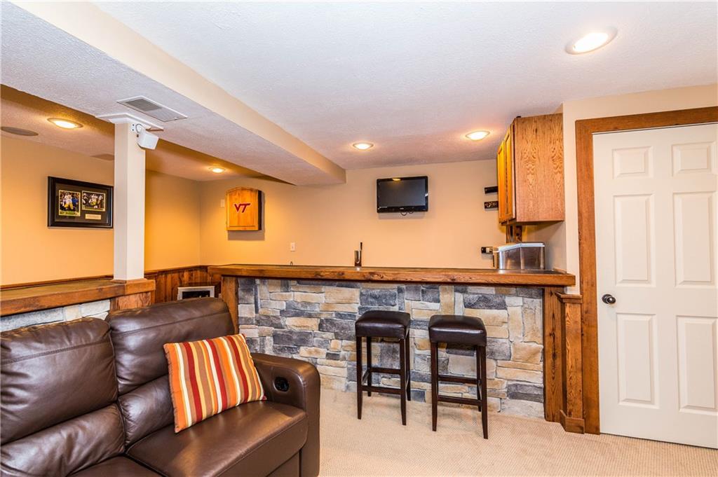 1440 Freeport Road Mars, PA 16046 - Photo 20 of 25 A GREAT ROOM FOR ALL OF YOUR ENTERTAINING FEATURES A WELL EQUIPPED BEAUTIFUL STONE BAR. YOU WILL BE AMAZED BY THE AMOUNT OF STORAGE AREAS IN THIS HOME.