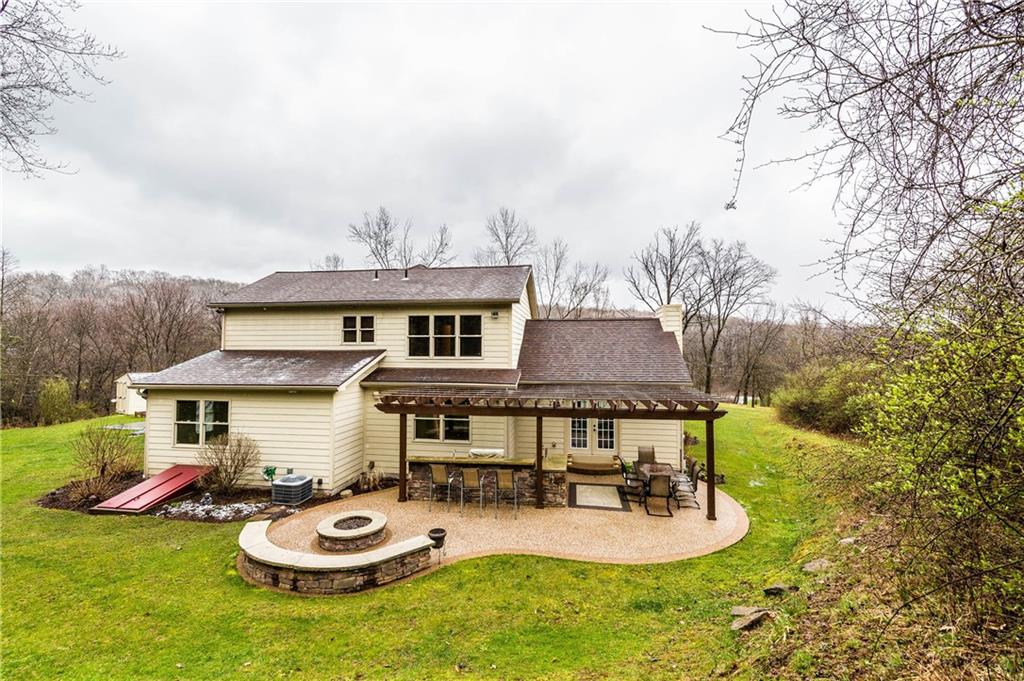 1440 Freeport Road Mars, PA 16046 - Photo 21 of 25 BUILT IN OUTDOOR KITCHEN UNDER A BEAUTIFUL PERGOLA. VERY PRIVATE REAR ENTERTAINMENT AREA FEATURES A BUILT IN STONE FIRE PIT.