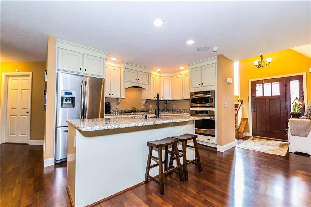1440 Freeport Road Mars, PA 16046 - Photo 6 of 25 ANOTHER VIEW OF THE OPEN FLOOR PLAN OPENING TO THE ENTRY. WALL OVEN AND MICROWAVE/CONVECTION OVEN.
