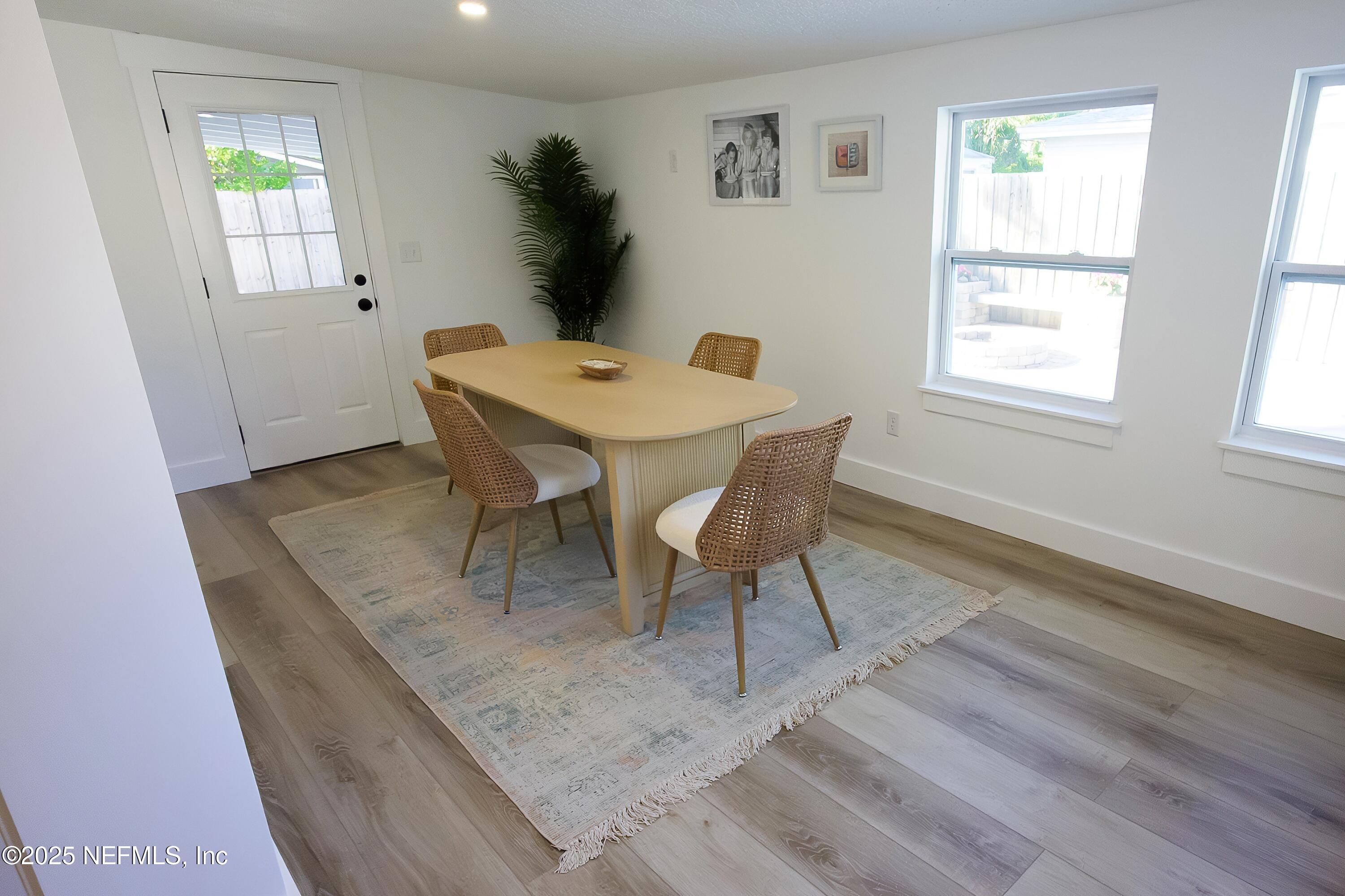 785 Triton Road Atlantic Beach, FL 32233 - Photo 11 of 46 a view of a dining room with furniture and wooden floor