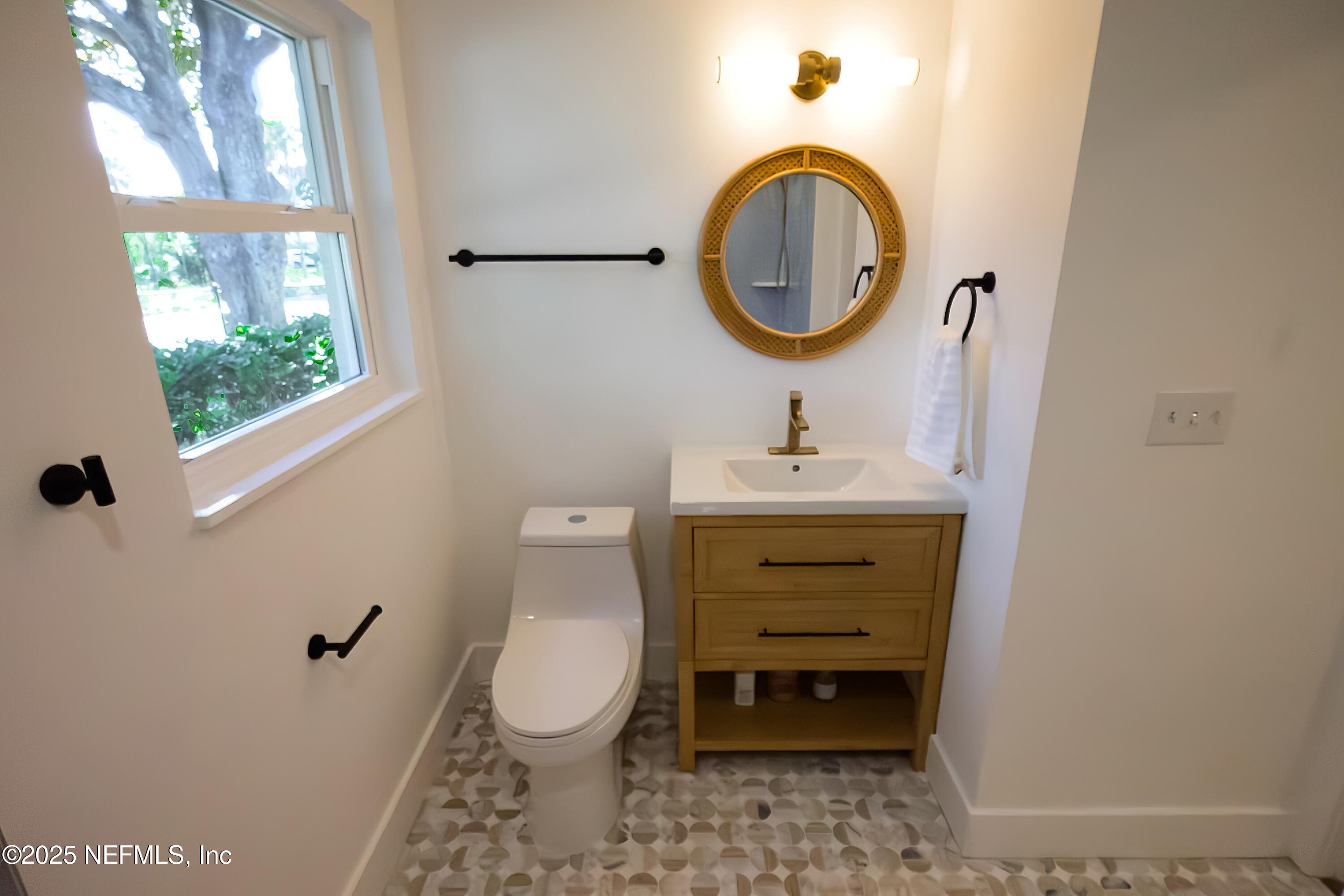 785 Triton Road Atlantic Beach, FL 32233 - Photo 21 of 46 a bathroom with a sink toilet and a mirror