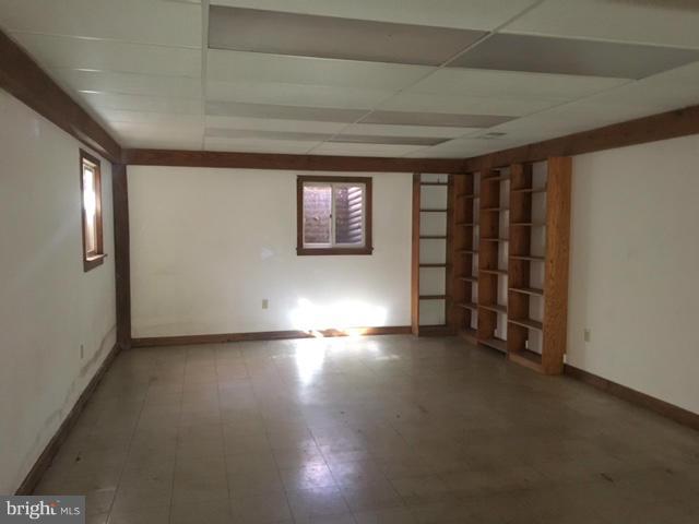 13728 Pryor Road Thurmont, MD 21788 - Photo 17 of 22 an empty room with staircase painted walls & windows