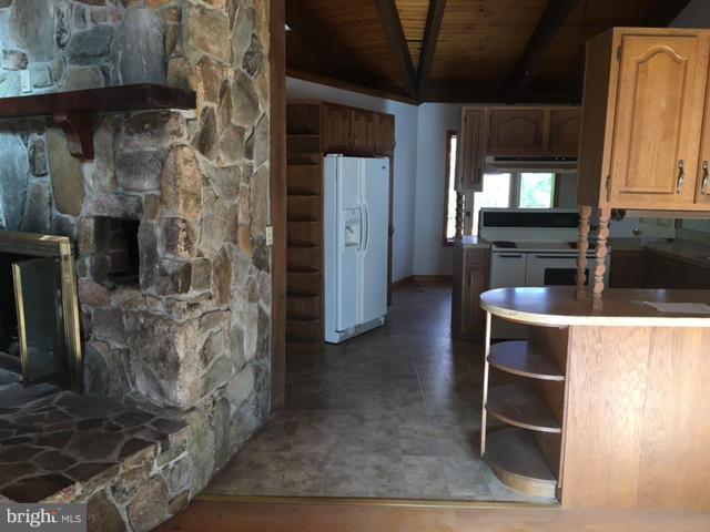 13728 Pryor Road Thurmont, MD 21788 - Photo 5 of 22 a kitchen with stainless steel appliances kitchen island granite countertop a refrigerator and a stove top oven