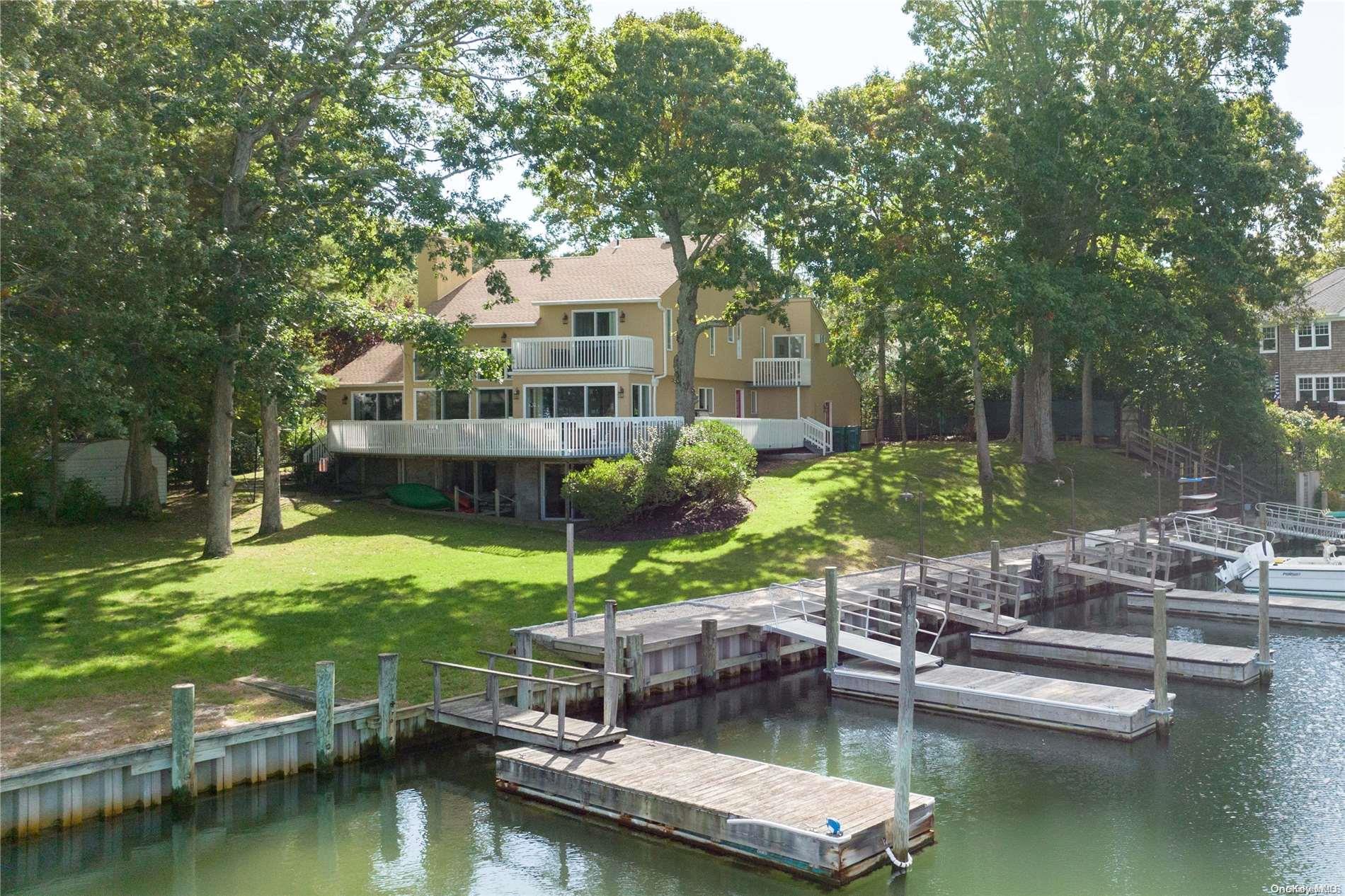 a view of house with swimming pool and a yard