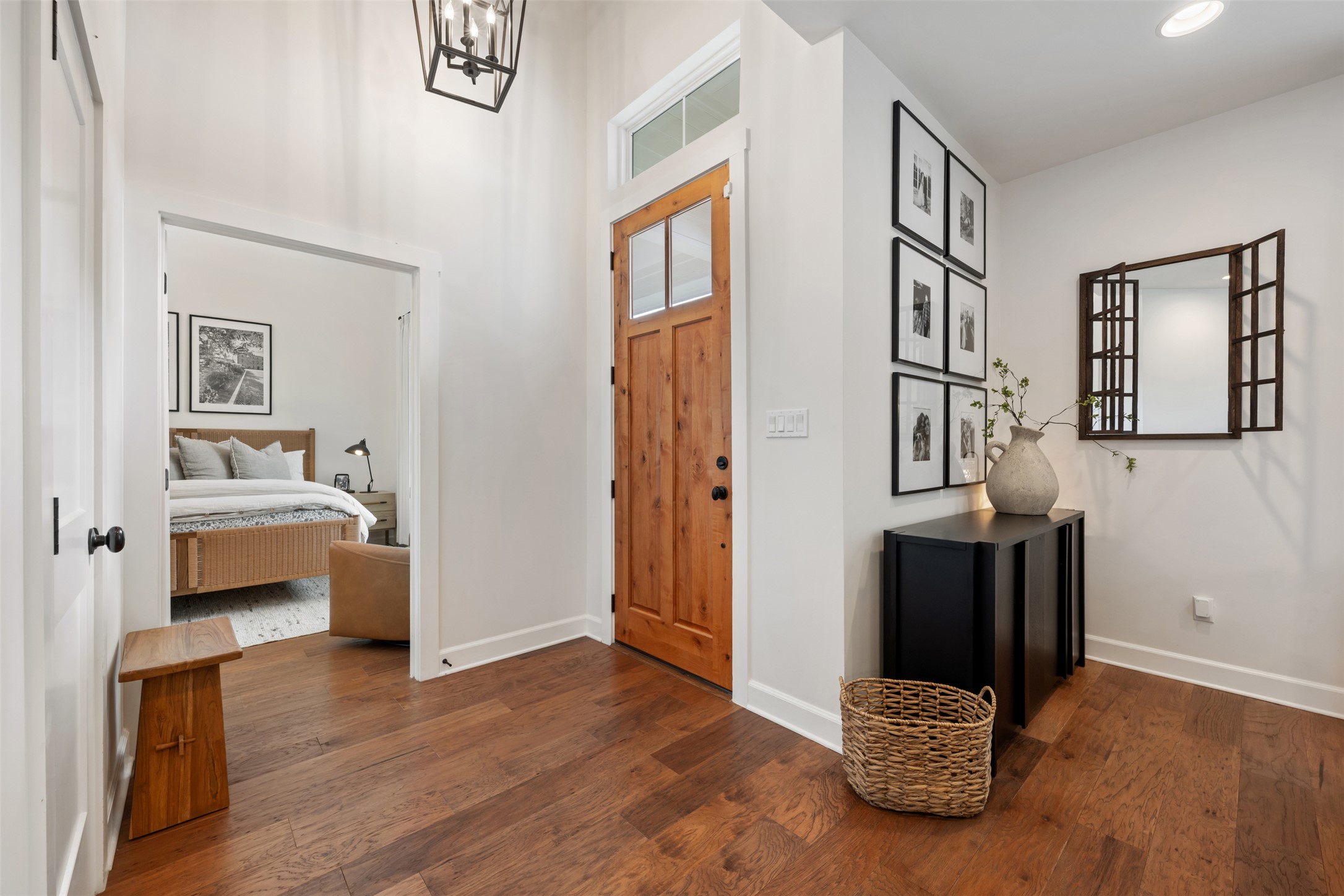1301 West Street Georgetown, TX 78626 - Photo 5 of 40 A welcoming entryway with rich wood flooring and a modern chandelier provides a pleasant first impression.