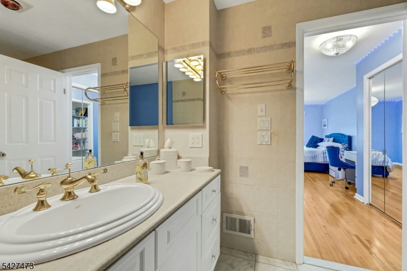 100 Easedale Road, Unit 100 Wayne, NJ 07470 - Photo 26 of 43 a en suite bathroom with a sink double vanity and a mirror