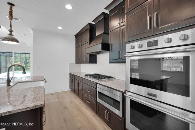 a view of kitchen with sink microwave and stove