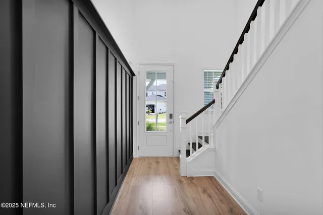 a view of entryway with wooden floor and stairs