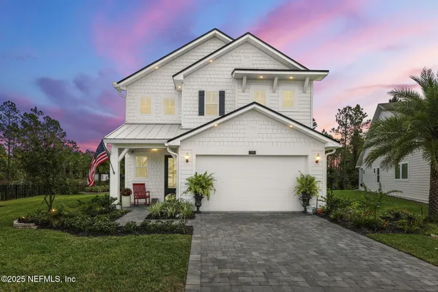 a view of a house with a swimming pool and a yard
