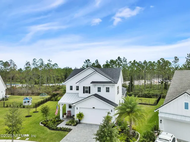 a front view of house with yard and swimming pool
