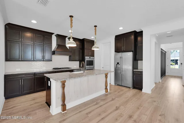 a kitchen with granite countertop stainless steel appliances and wooden cabinets
