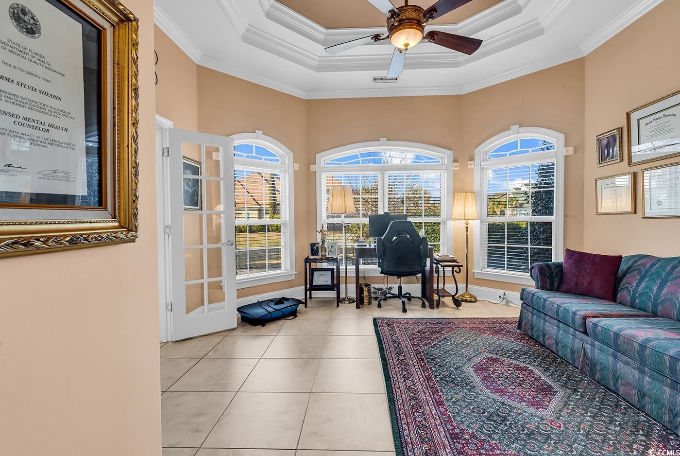 801 Bluffview Drive Myrtle Beach, SC 29579 - Photo 17 of 40 Office featuring a tray ceiling, crown molding, healthy amount of natural light, a ceiling fan, and tile patterned flooring