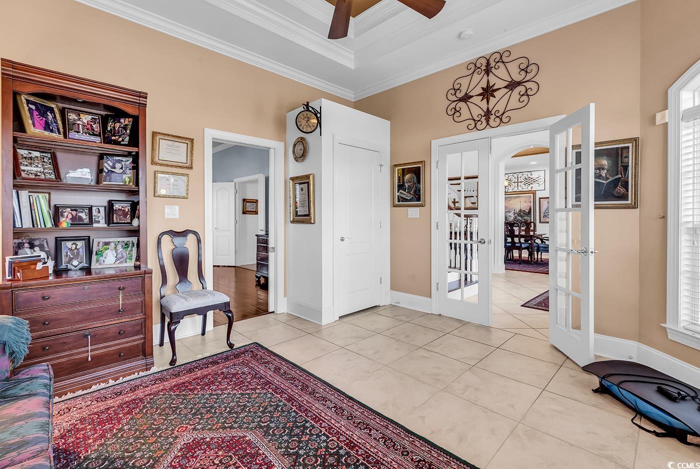 801 Bluffview Drive Myrtle Beach, SC 29579 - Photo 18 of 40 Sitting room featuring french doors, light tile patterned floors, a ceiling fan, and ornamental molding