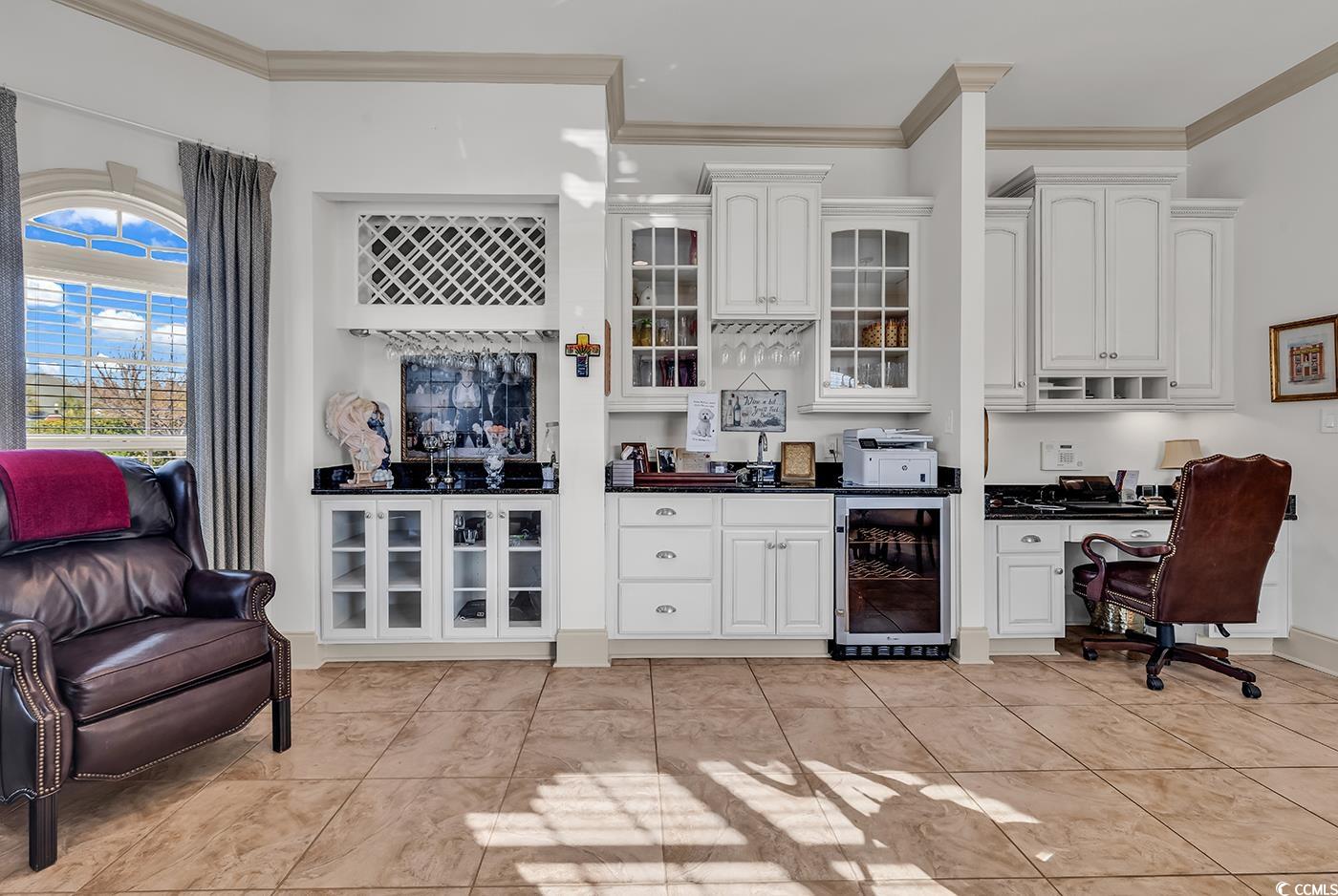 801 Bluffview Drive Myrtle Beach, SC 29579 - Photo 22 of 40 Bar area featuring dark countertops, wine cooler, ornamental molding, built in study area, and white cabinets