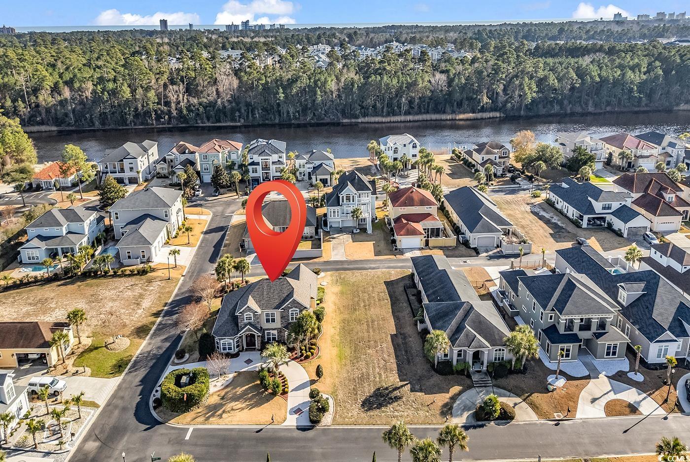 801 Bluffview Drive Myrtle Beach, SC 29579 - Photo 37 of 40 Aerial view of residential area with a large body of water and a forest
