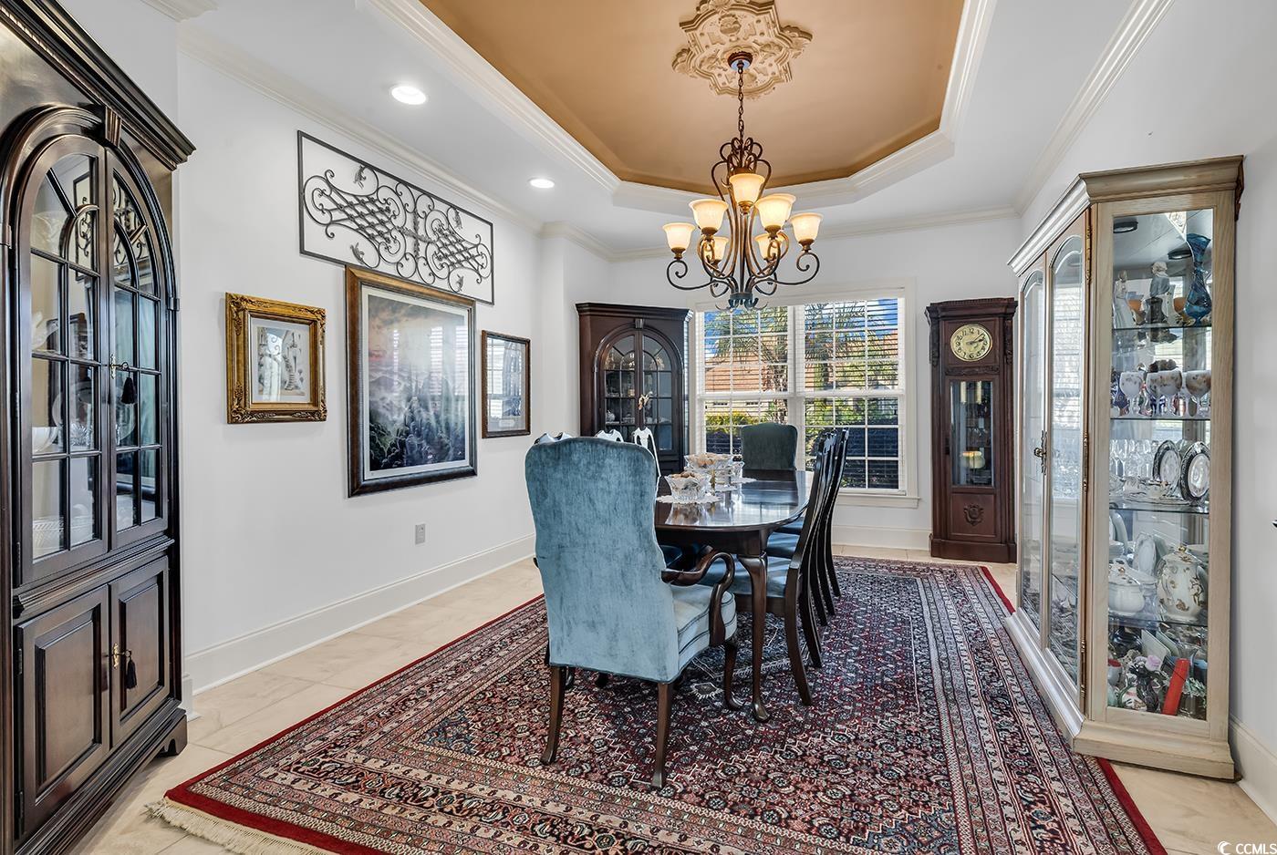 801 Bluffview Drive Myrtle Beach, SC 29579 - Photo 5 of 40 Dining room featuring crown molding, a chandelier, and a raised ceiling
