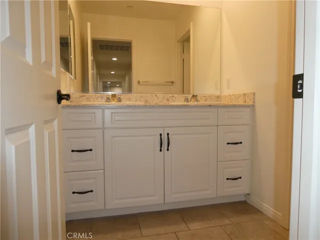 a view of a bathroom with two mirror and a sink