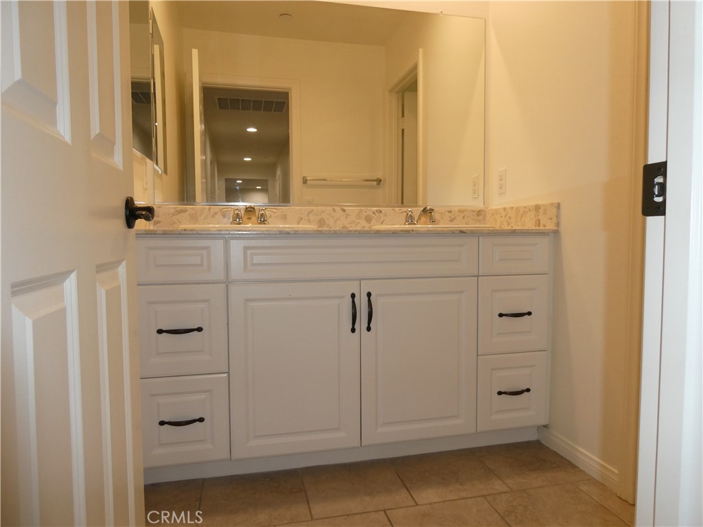 7613 Steamboat Street Riverside, CA 92507 - Photo 14 of 17 a view of a bathroom with two mirror and a sink