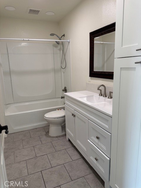 7613 Steamboat Street Riverside, CA 92507 - Photo 4 of 17 a bathroom with a granite countertop sink a toilet and a bathtub