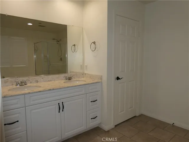 a bathroom with a granite countertop sink a mirror and a
