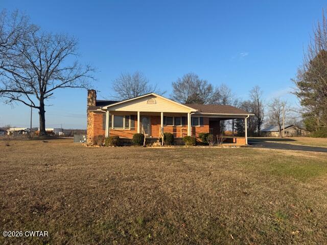 2455 Highway 64 Adamsville, TN 38310 - Photo 1 of 18 a front view of a house with a yard