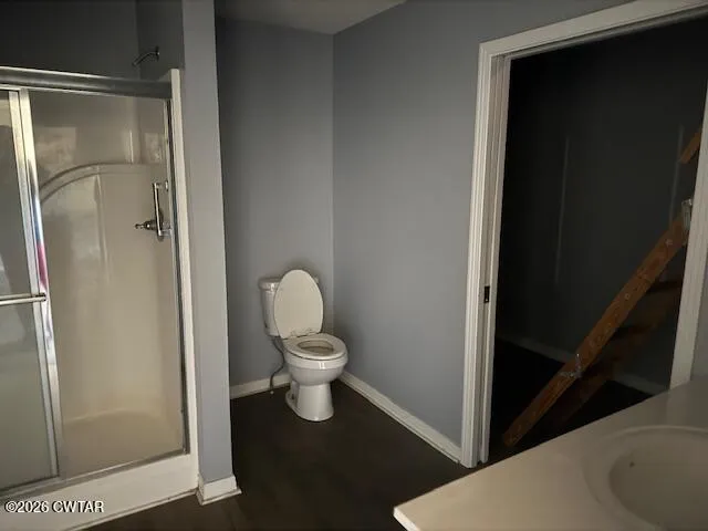 a bathroom with a toilet and a shower