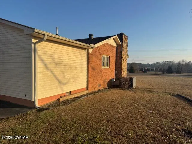 a backyard of a house with lake view and a large window