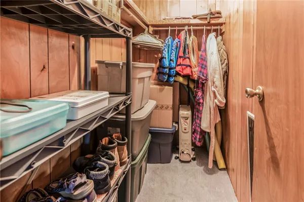 a view of walk in closet with clothes