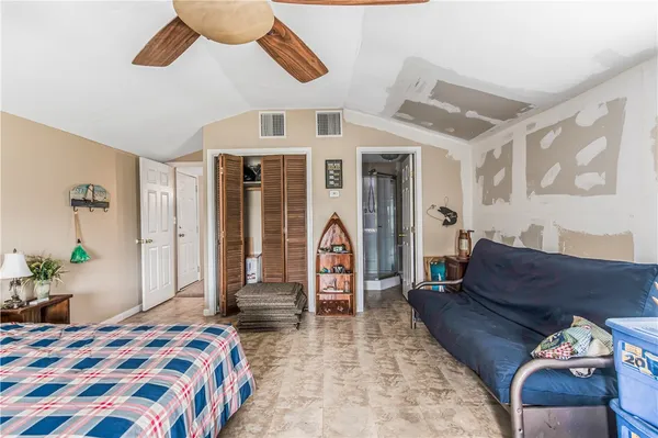 a bedroom with a bed and a chandelier