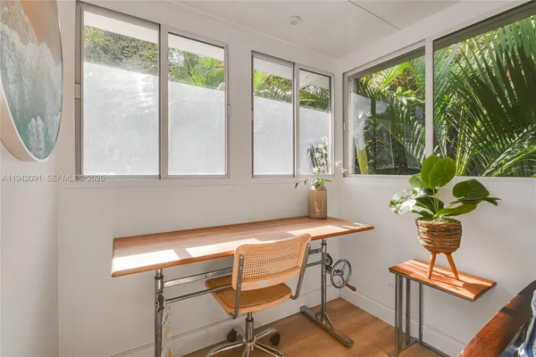 a view of a room with a table and chairs