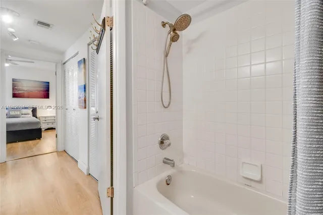 a en suite bathroom with a tub shower and bedroom