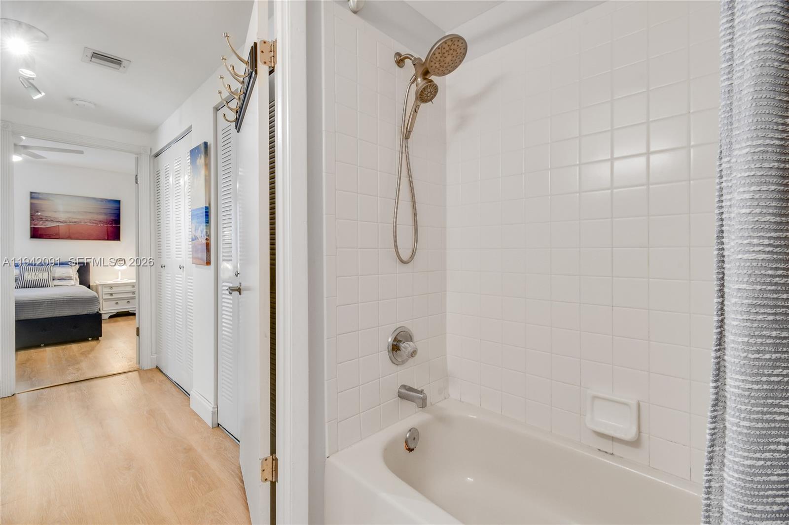 353 Highway 1, Unit B6 Jupiter, FL 33477 - Photo 16 of 23 a en suite bathroom with a tub shower and bedroom