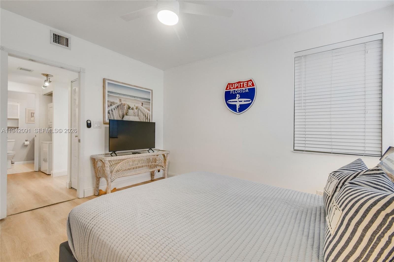353 Highway 1, Unit B6 Jupiter, FL 33477 - Photo 18 of 23 a bedroom with a bed and a flat screen tv