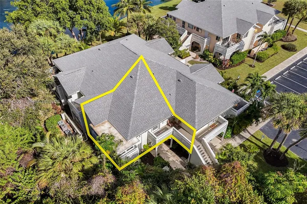 an aerial view of a house with swimming pool and outdoor space