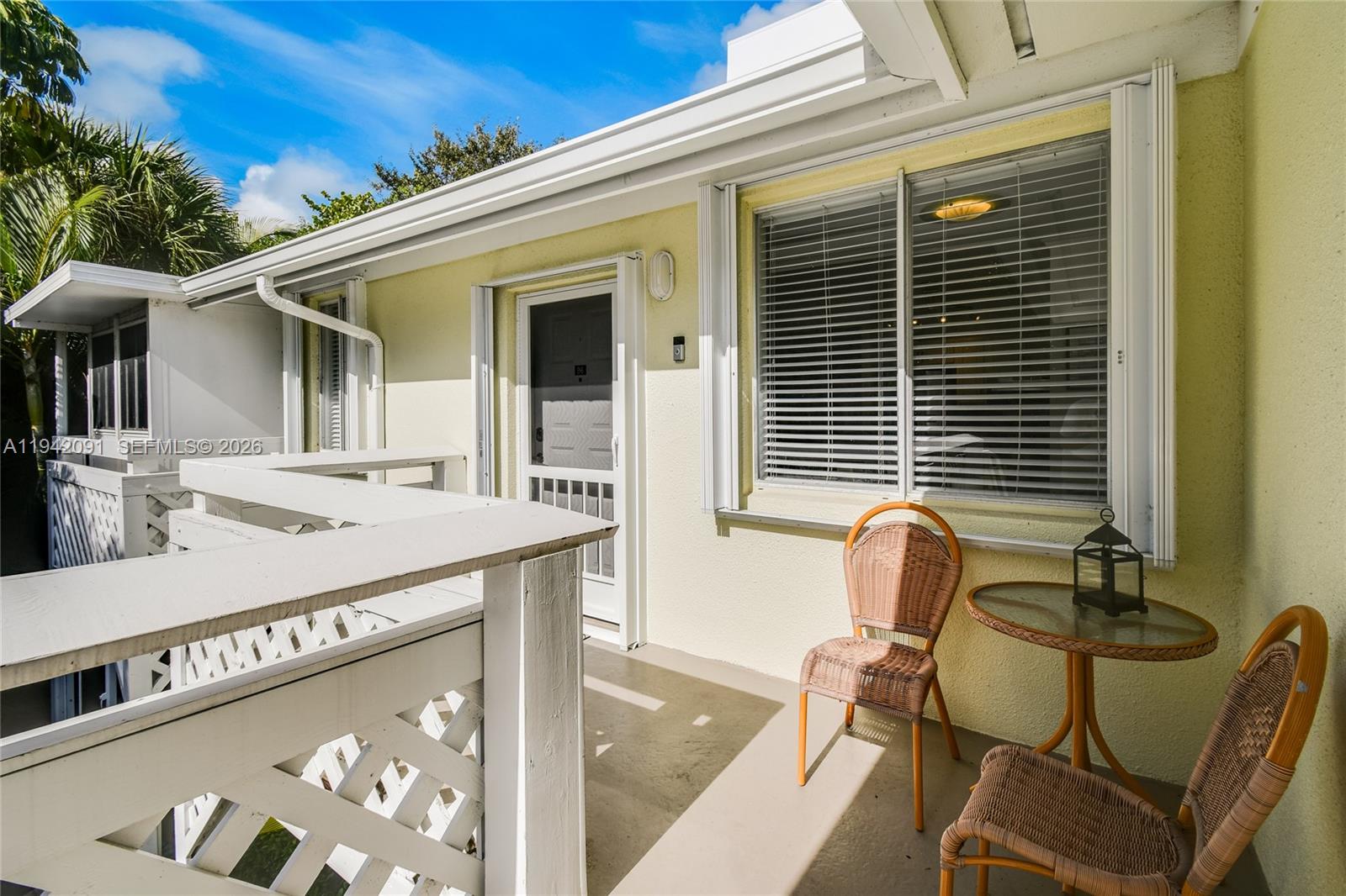 353 Highway 1, Unit B6 Jupiter, FL 33477 - Photo 2 of 23 a view of a patio with table and chairs and wooden floor
