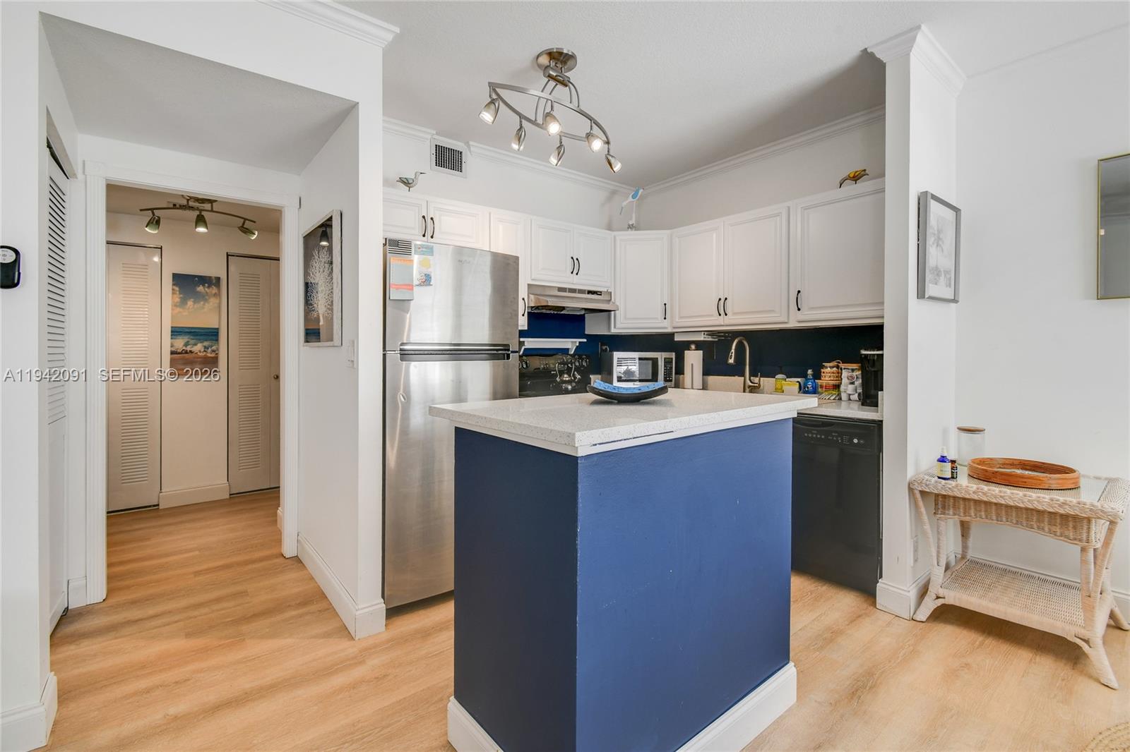 353 Highway 1, Unit B6 Jupiter, FL 33477 - Photo 8 of 23 a kitchen with stainless steel appliances a refrigerator stove and sink